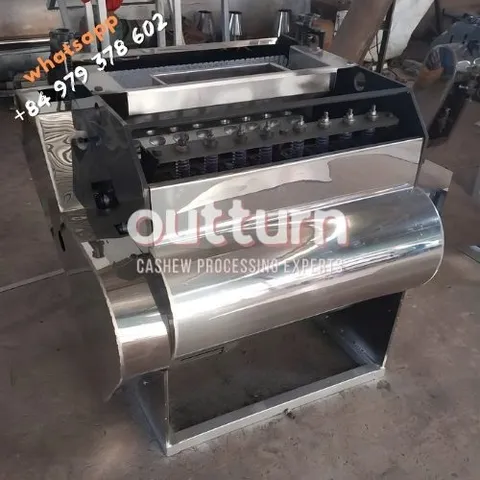 OUTTURN 10-head cashew nut cutting machine with ten rotary cutting cups on a steel frame