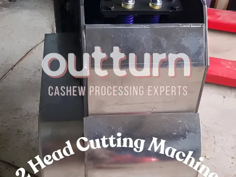 OUTTURN 2-head cashew cutting machine showing twin stainless steel cutting cups and blade assembly