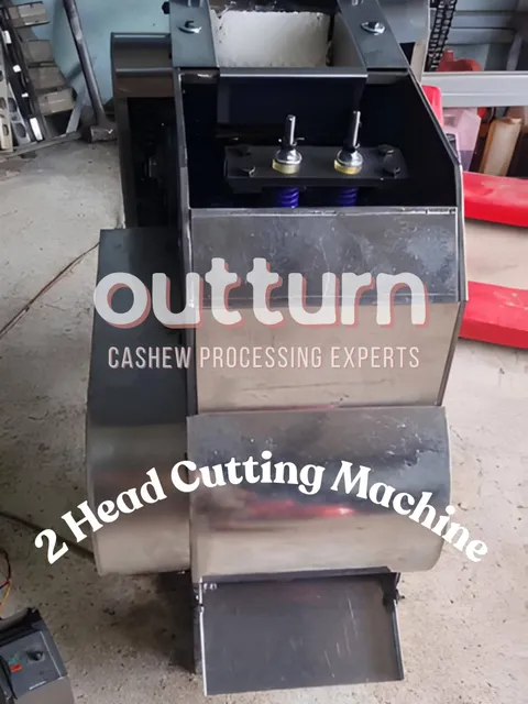 OUTTURN 2-head cashew cutting machine showing twin stainless steel cutting cups and blade assembly