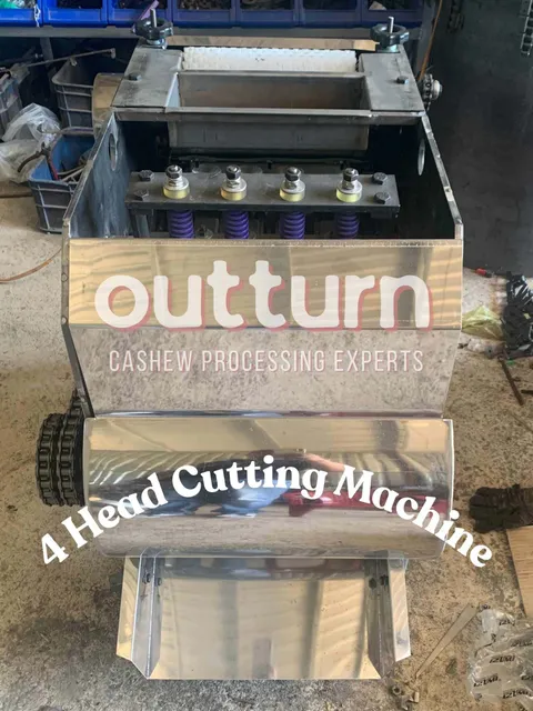 OUTTURN 4-head cashew nut cutting machine with four rotary cutting stations on a steel frame