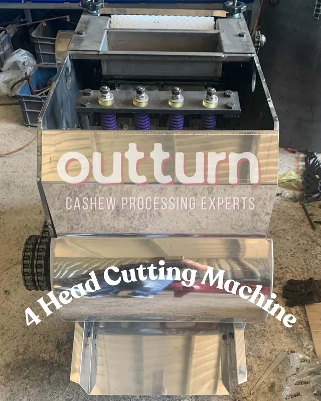 OUTTURN 4-head cashew nut cutting machine with four rotary cutting stations on a steel frame