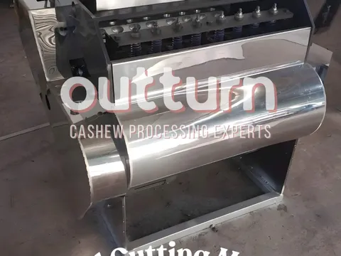 OUTTURN 8-head cashew nut cutting machine showing eight rotary cutting cups arranged around the central turret