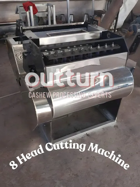 OUTTURN 8-head cashew nut cutting machine showing eight rotary cutting cups arranged around the central turret