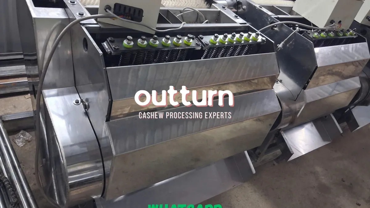 Two OUTTURN rotary cashew cutting machines side by side on the factory floor in Bình Phước, Vietnam