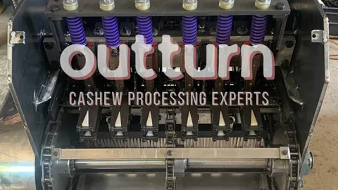 Electric motor and control panel on an OUTTURN cashew cutting machine on a factory floor