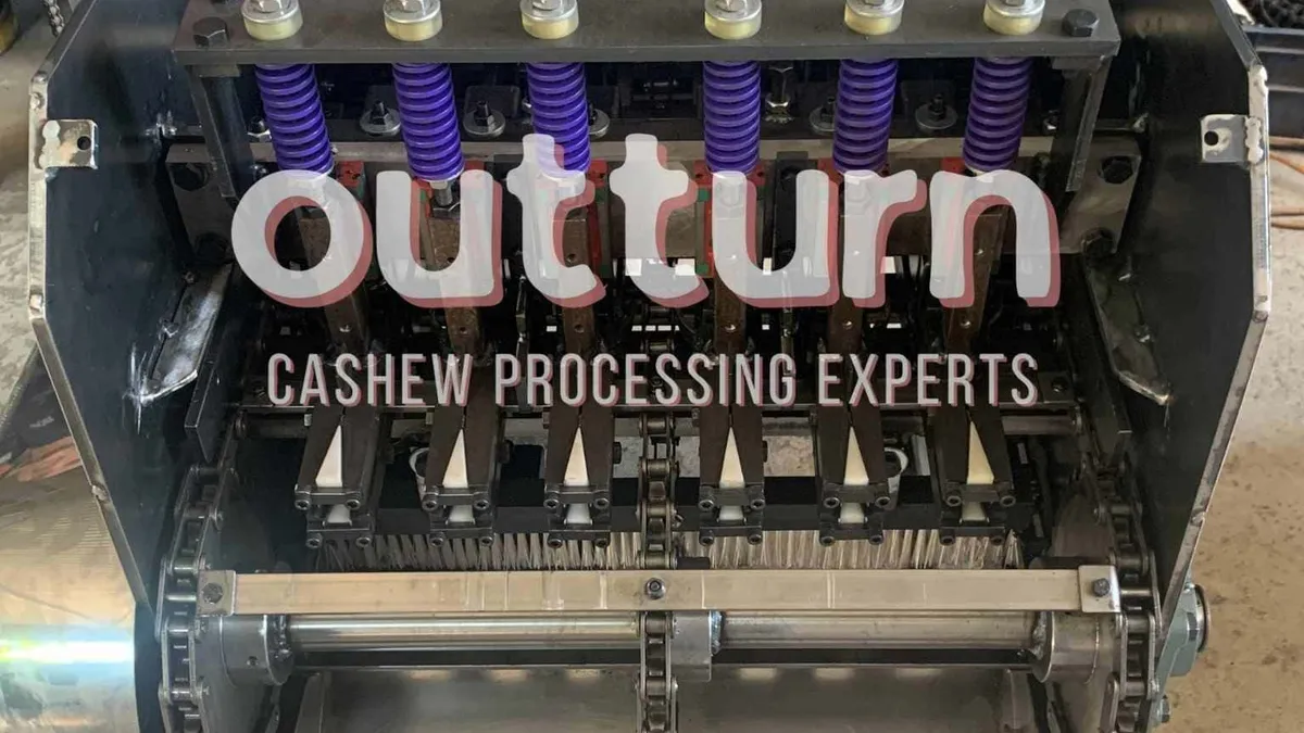 Electric motor and control panel on an OUTTURN cashew cutting machine on a factory floor