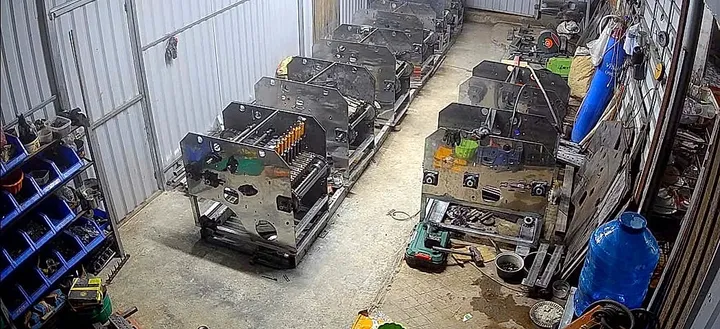 A batch of machines mid-assembly, lined up on the shop floor
