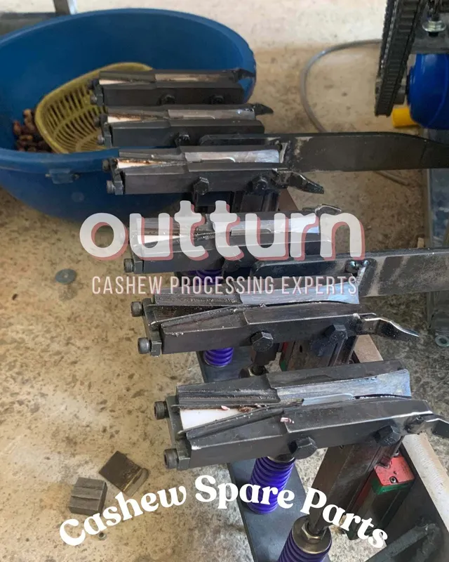 Shelves of genuine OUTTURN cashew cutting machine spare parts including blades, cutting cups and blade assemblies